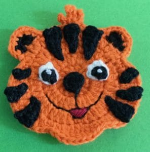 Crochet crouching tiger head with spots