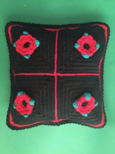 Finished crochet flower cushion black portrait