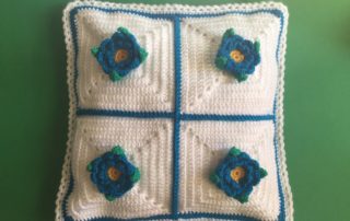 Finished crochet flower cushion white landscape