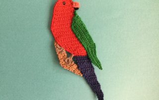 Finished crochet king parrot landscape