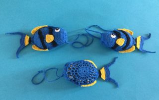 Finished crochet fish scrubbie group landscape