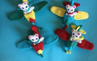 Finished crochet teddy for plane mobile in plane group landscape