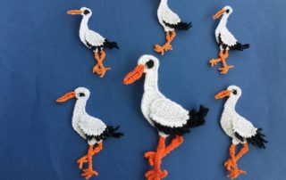 Finished crochet stork 2 ply group dark blue background landscape