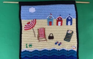 Finished crochet wall hanging with bamboo landscape