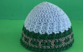 Finished train track beanie green background landscape