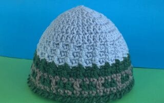 Finished train track beanie green and blue background landscape