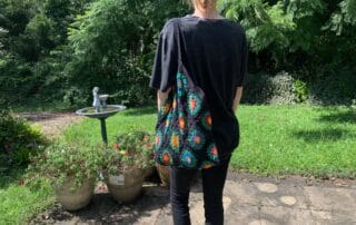 Finished crochet granny square shopping bag black with model landscape 1