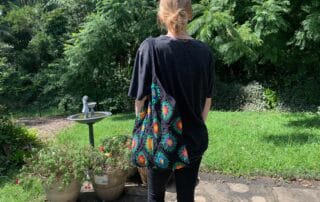 Finished crochet granny square shopping bag black with model landscape