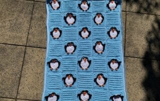 Finished crochet penguin baby blanket landscape