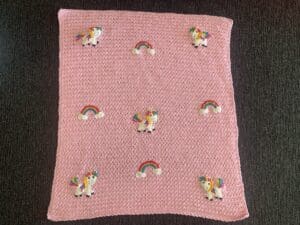 Finished crochet unicorn baby blanket landscape