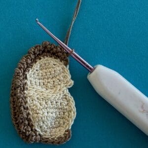 Crochet sitting hedgehog 2 ply joining for spikes row 2